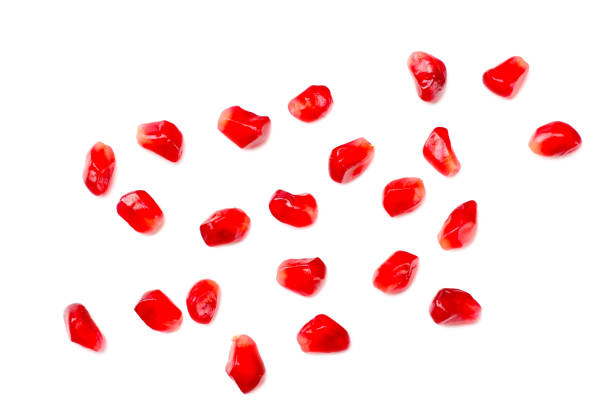 istock pomegranate seeds isolated on white background. top view 1155281131