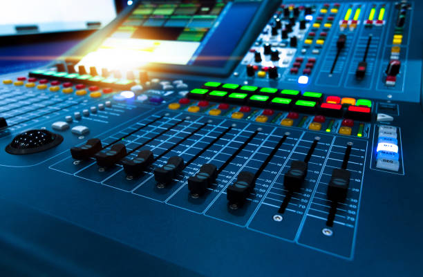 istock Professional audio studio sound mixer console board panel with recording , faders and adjusting knobs,TV equipment. Blue tone and close-up image with flare light effect. 1155281841