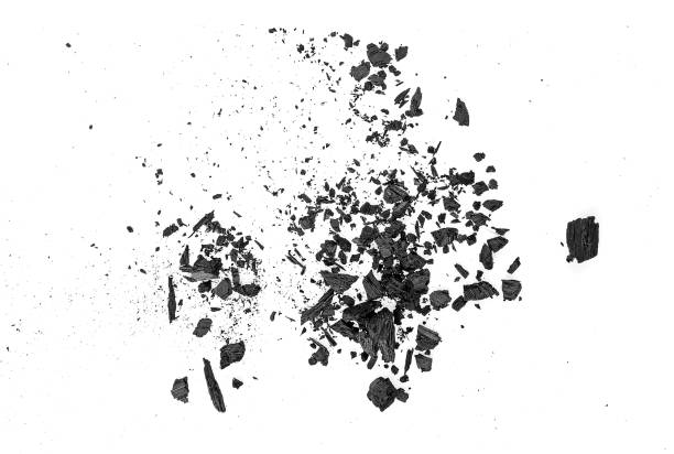 istock Small pieces of charcoal dust on white background, top view. 1155281985