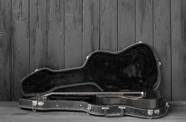 istock black guitar on a black wooden background 1155282100