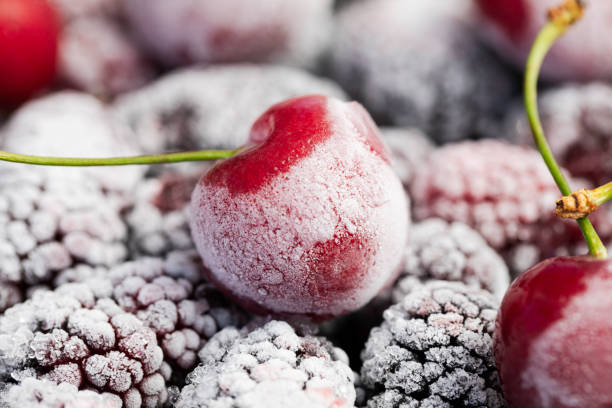 Frozen Fruits Extreme closeup of frozen mulberries and cherries. frozen food stock pictures, royalty-free photos & images