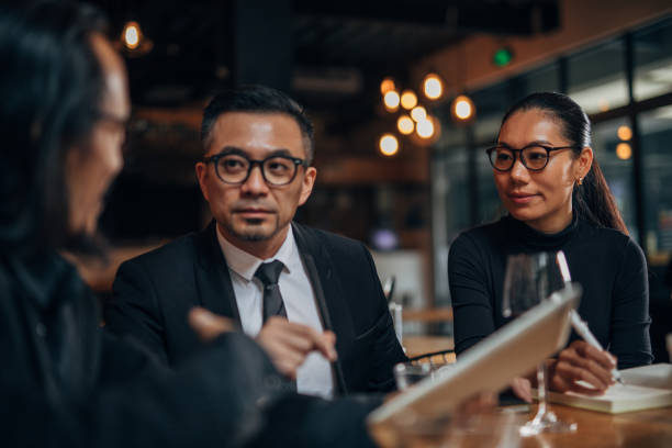 istock Business people sitting in restaurant 1155287357