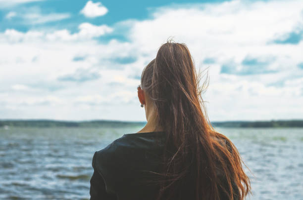 istock Young woman look at sea horison 1155287500