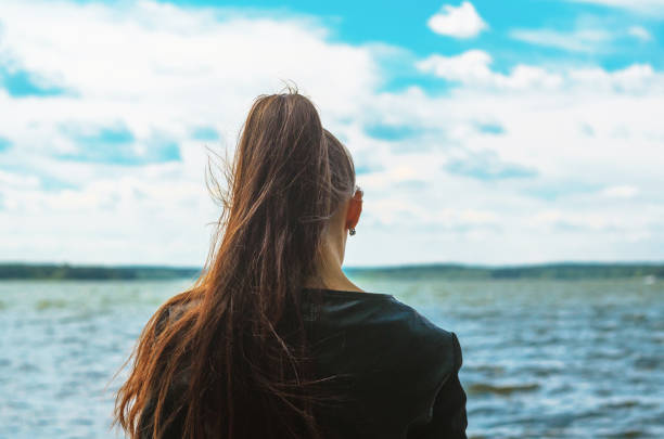 istock Young woman look at sea horison 1155287546