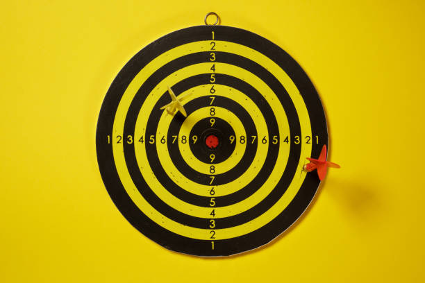 istock Yellow and red arrows darts hitting the target dartboard 1155291156