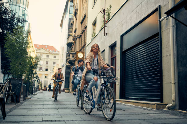 istock Friends Riding Bicycles In A City 1155292118