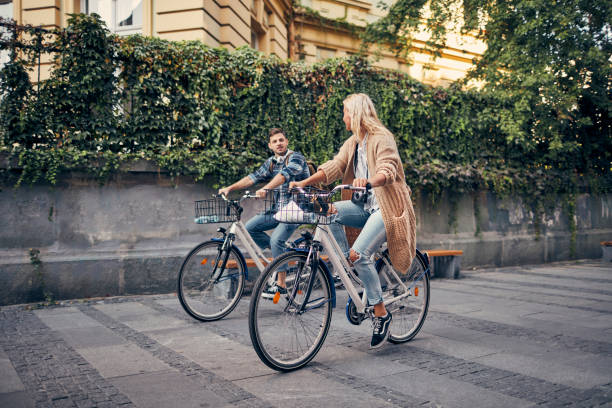 istock Friends Riding Bicycles In A City 1155292121