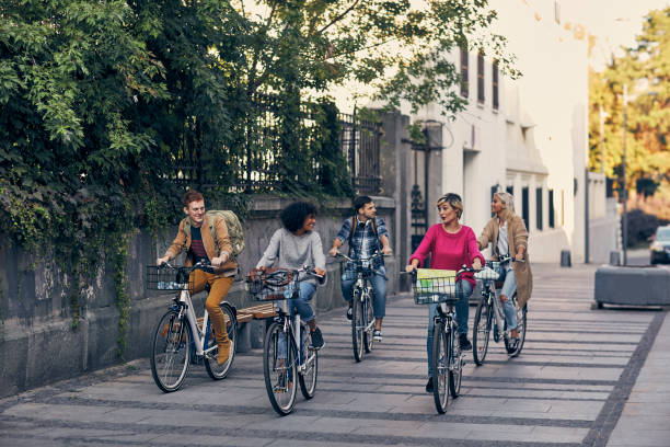 istock Friends Riding Bicycles In A City 1155292268
