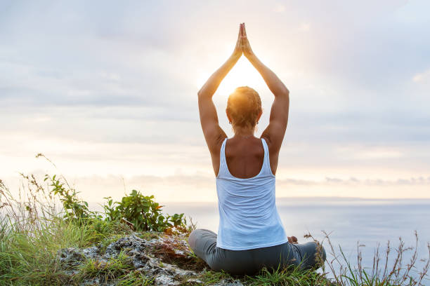 istock Caucasian woman practicing yoga at seashore 1155292407