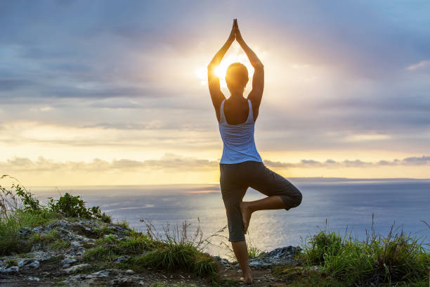 istock Caucasian woman practicing yoga at seashore 1155292419