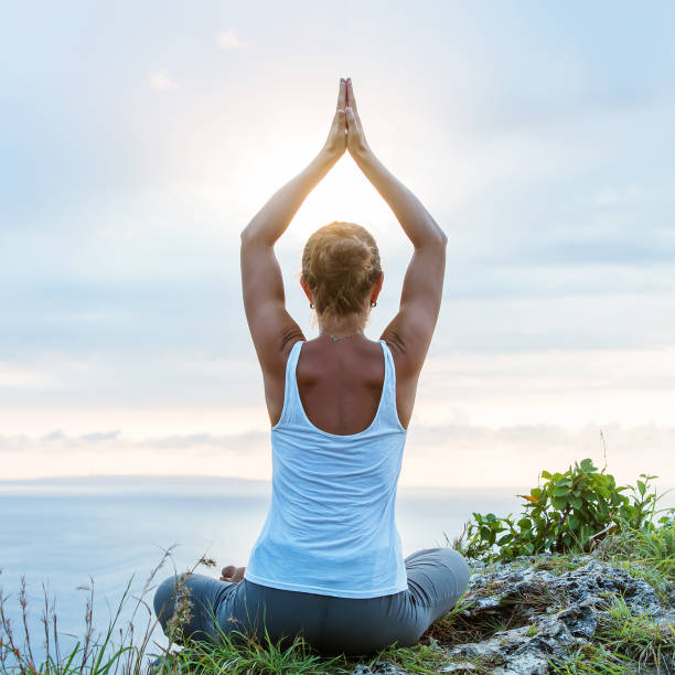 istock Caucasian woman practicing yoga at seashore 1155292430