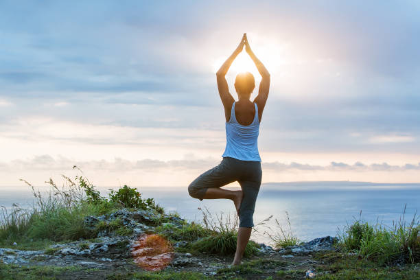 istock Caucasian woman practicing yoga at seashore 1155292435