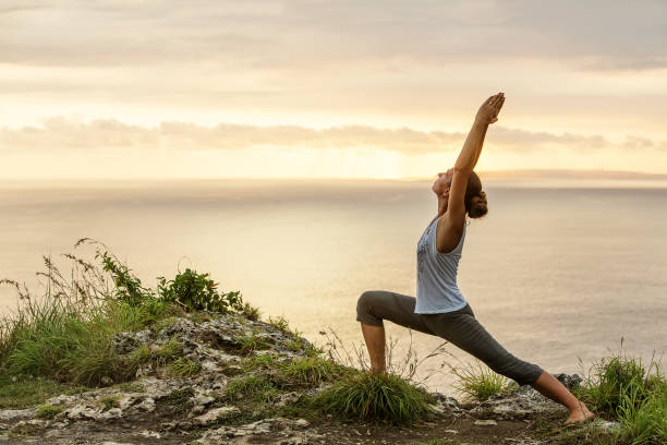 istock Caucasian woman practicing yoga at seashore 1155292447