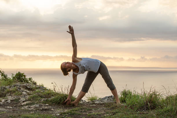istock Caucasian woman practicing yoga at seashore 1155292455