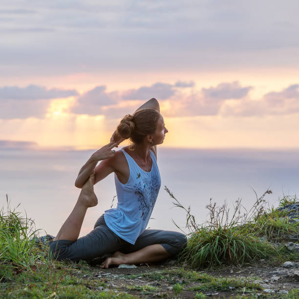 istock Caucasian woman practicing yoga at seashore 1155292469
