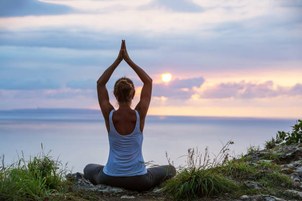 istock Caucasian woman practicing yoga at seashore 1155292483