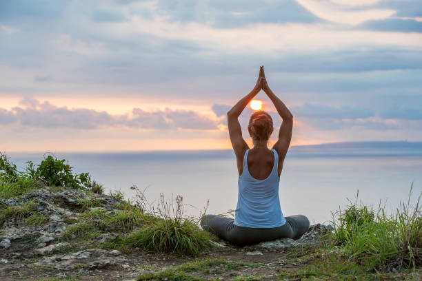 istock Caucasian woman practicing yoga at seashore 1155292496
