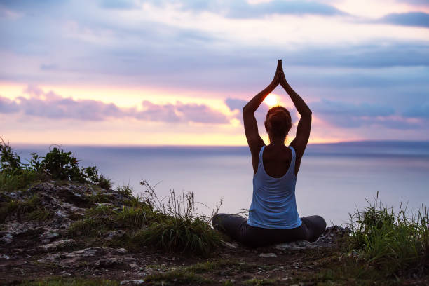 istock Caucasian woman practicing yoga at seashore 1155292503