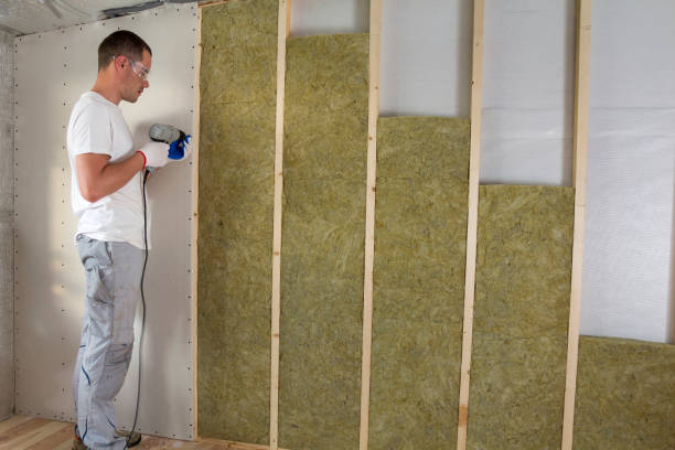istock Worker in goggles with screwdriver working on insulation. Drywall on wall beams, insulating rock wool staff in wooden frame. Comfortable warm home, economy, construction and renovation concept. 1155293524