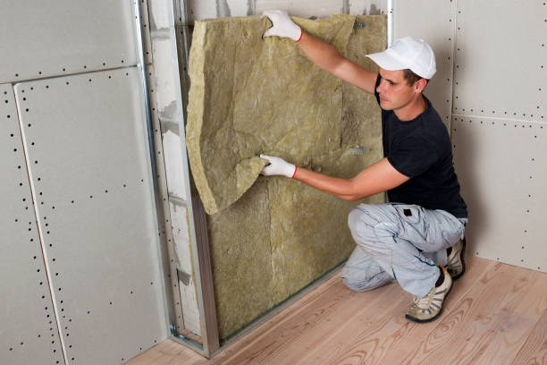 istock Worker in protective gloves insulating rock wool insulation in wooden frame for future house walls for cold barrier. Comfortable warm home, economy, construction and renovation concept 1155293548