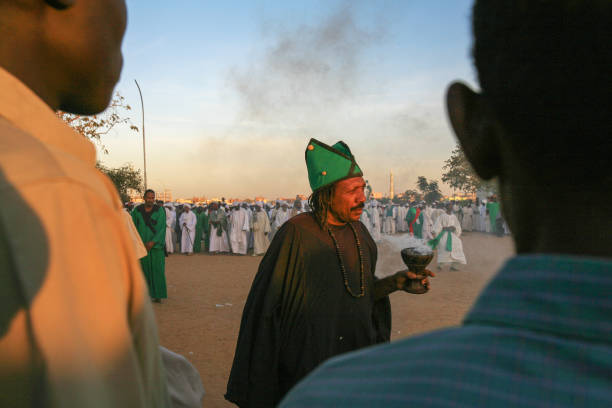 The Sufi whirling Dervishes dancers of Omdurman, Khartoum, Sudan Omdurman, Khartoum, Sudan - January 29, 2010: every Friday afternoon at sunset the Sufi Whirling Dervishes dressed in colorful clothes gather in circle next to the Hamed al Nil mosque to sing and perform their ritual dances, whirling and filling the air with the perfume of frankincense. Khartoum is the capital and largest city of Sudan, located at the confluence of the White Nile, flowing north from Lake Victoria in Uganda, and the Blue Nile, flowing west from Ethiopia. Khartoum is composed of 3 cities: Khartoum proper, Khartoum North and Omdurman. blue nile stock pictures, royalty-free photos & images
