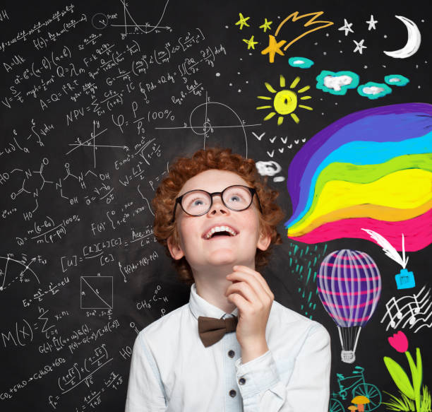 istock Science and arts occupations. Smiling smart boy kid on blackboard background with maths formula and art pattern 1155294385