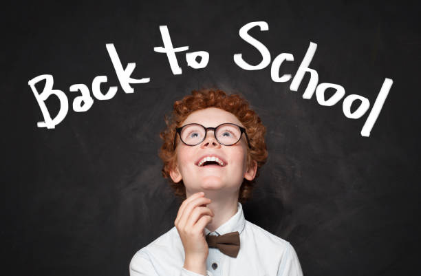 istock Back to school text and happy kid on chalkboard background 1155294449