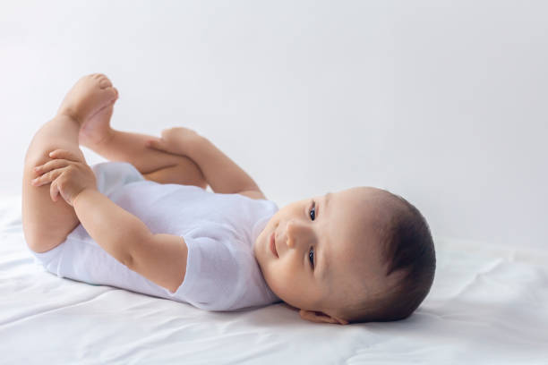 istock Cute baby boy lying on bed 1155297066