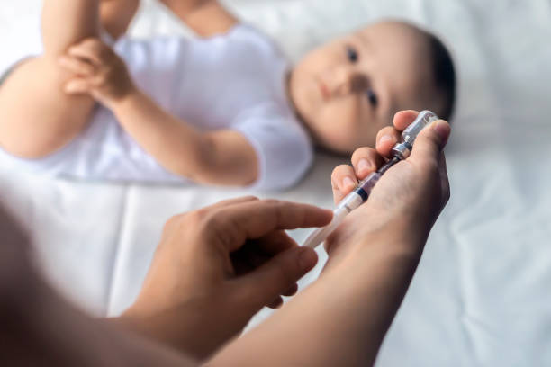 istock Doctor vaccinating newborn baby 1155297908