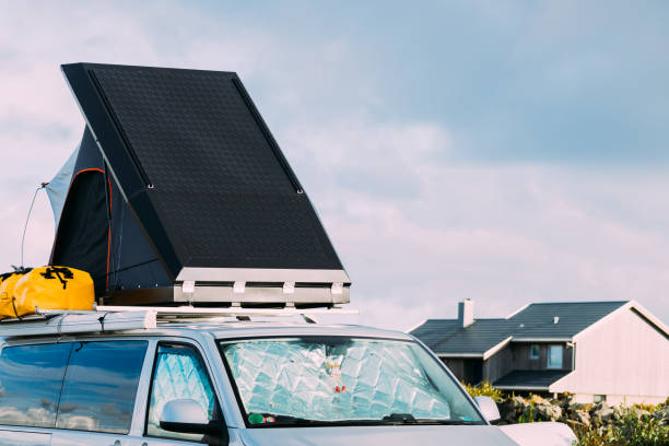 istock Camper van with tent on roof on roadside 1155299155