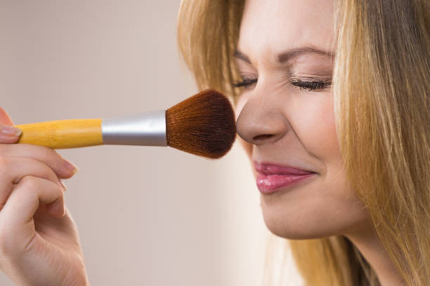 istock Smiling woman holding make up brush 1155300228