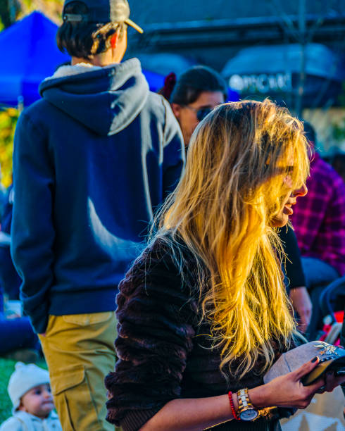 MONTEVIDEO, URUGUAY, JUNE - 2019 - Attractive blonde woman selling hats at outdoor street fair at carrasco neighborhood, montevideo city, uruguay