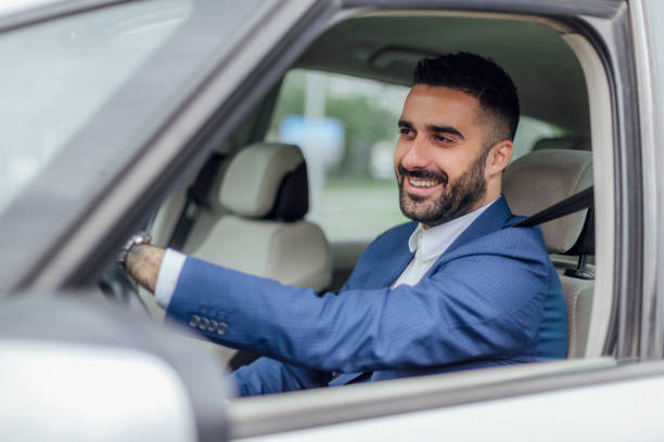 istock Handsome businessman traveling in a car. 1155311223