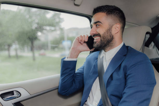 istock Handsome businessman traveling in a car. 1155313663