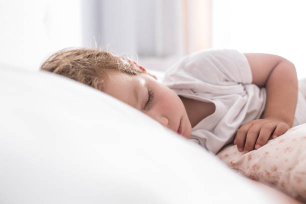 istock 3 years toddler boy sleeping the siesta on bed 1155313737