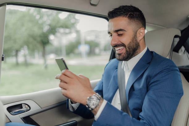 istock Handsome businessman traveling in a car. 1155313802
