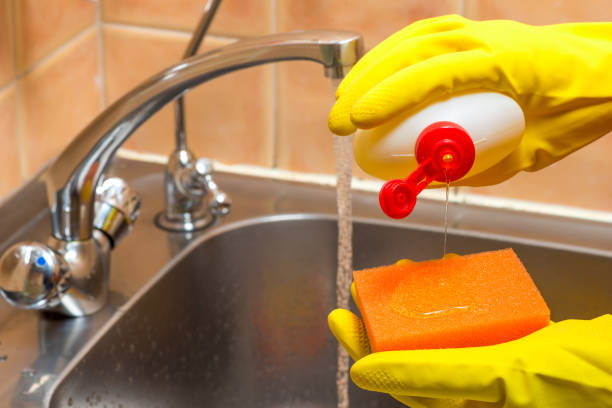 istock gloved hands with dishwashing liquid and a sponge in the kitchen closeup 1155320432