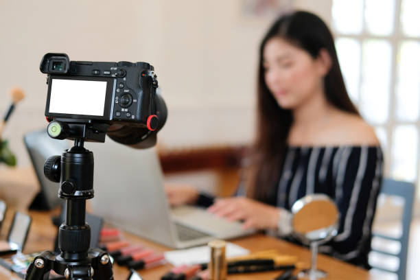 istock beauty blogger live broadcasting cosmetic makeup tutorial on social media. 1155320596