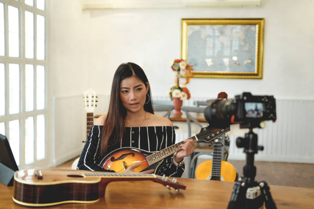 istock blogger live broadcasting music instrument tutorial on social media. vlogger recording online vlog video. 1155320599