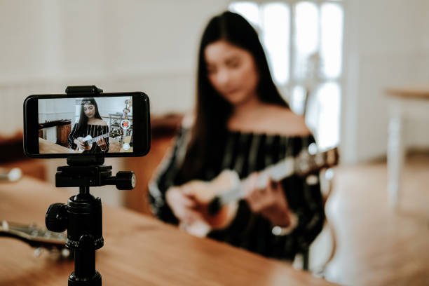 istock blogger live broadcasting music instrument tutorial on social media. vlogger recording online vlog video. 1155320600