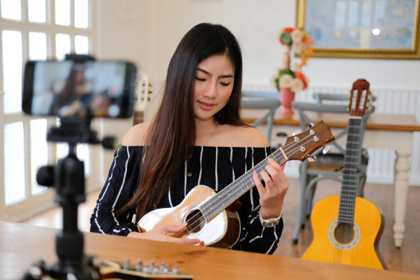 istock blogger live broadcasting music instrument tutorial on social media. vlogger recording online vlog video. 1155320616