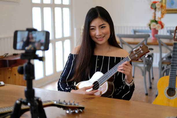 istock blogger live broadcasting music instrument tutorial on social media. vlogger recording online vlog video. 1155320623