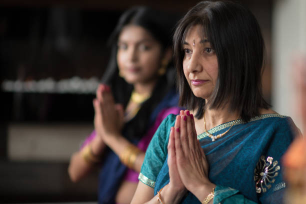istock Senior Indian Woman Praying 1155321194