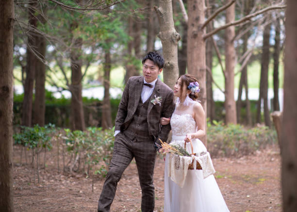istock Bride and groom walking in forest 1155321242
