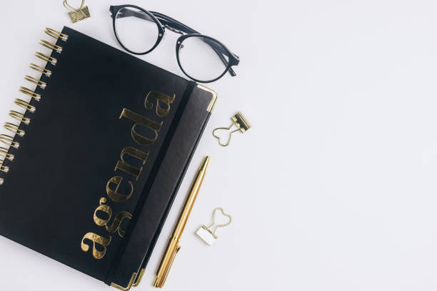 istock Flat lay home office desk. Female workspace with computer keyboard, golden accessories, glasses, black diary 1155322721