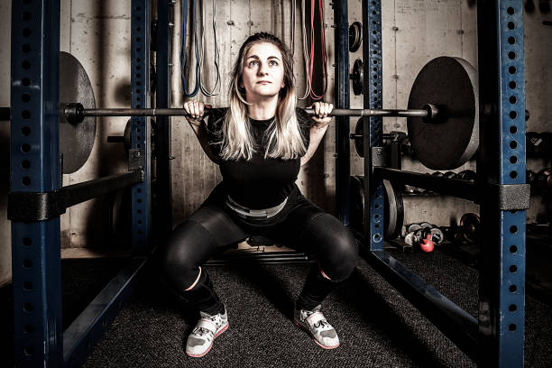 istock Young woman weight training in a gritty basement gym. 1155326262