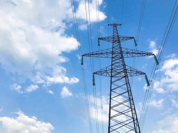 istock The power line. High voltage pole and blue sky on the background. Bottom view 1155326315