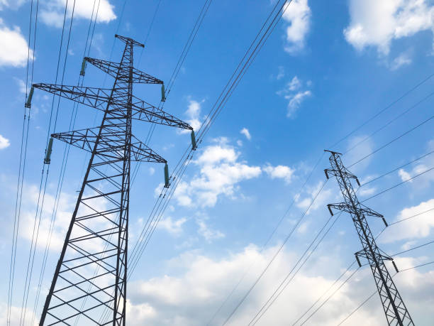 istock The power line. High voltage pole and blue sky on the background. Bottom view 1155327082