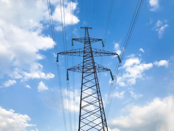 istock The power line. High voltage pole and blue sky on the background. Bottom view 1155327088