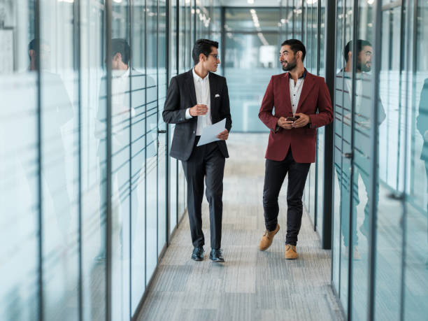 istock Business partners walking and talking 1155327989